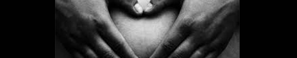 manos en forma de corazon en la barriga de una mujer embarazada